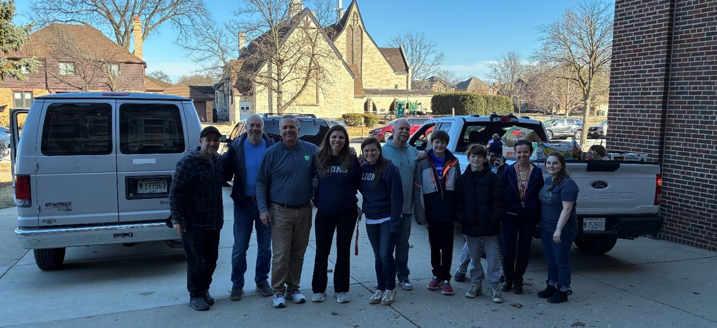 group of people standing by trucks